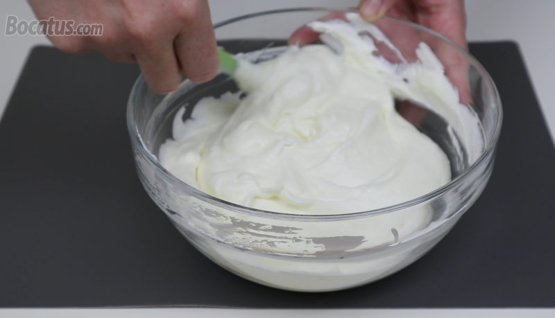 Integrando la nata montada en la mezcla de limón y leche condensada